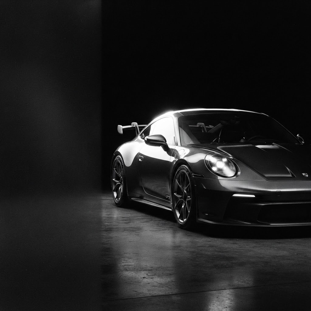 A European supercar photographed under dramatic studio lighting