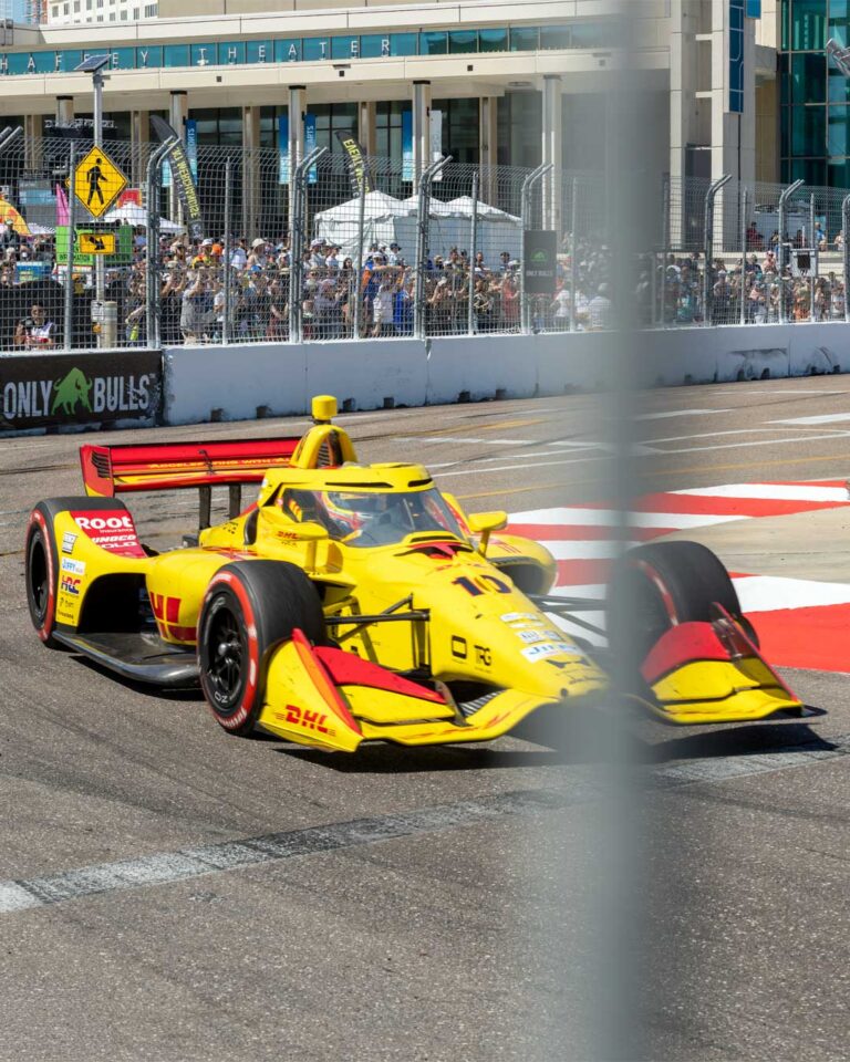 The No. 10 DHL car cornering in front of the Mahaffey Theater and a packed grandstand